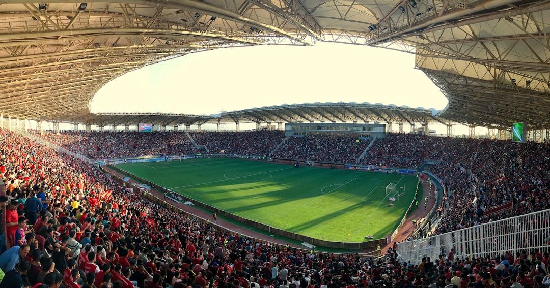 Football fans inside a stadium watching a live match