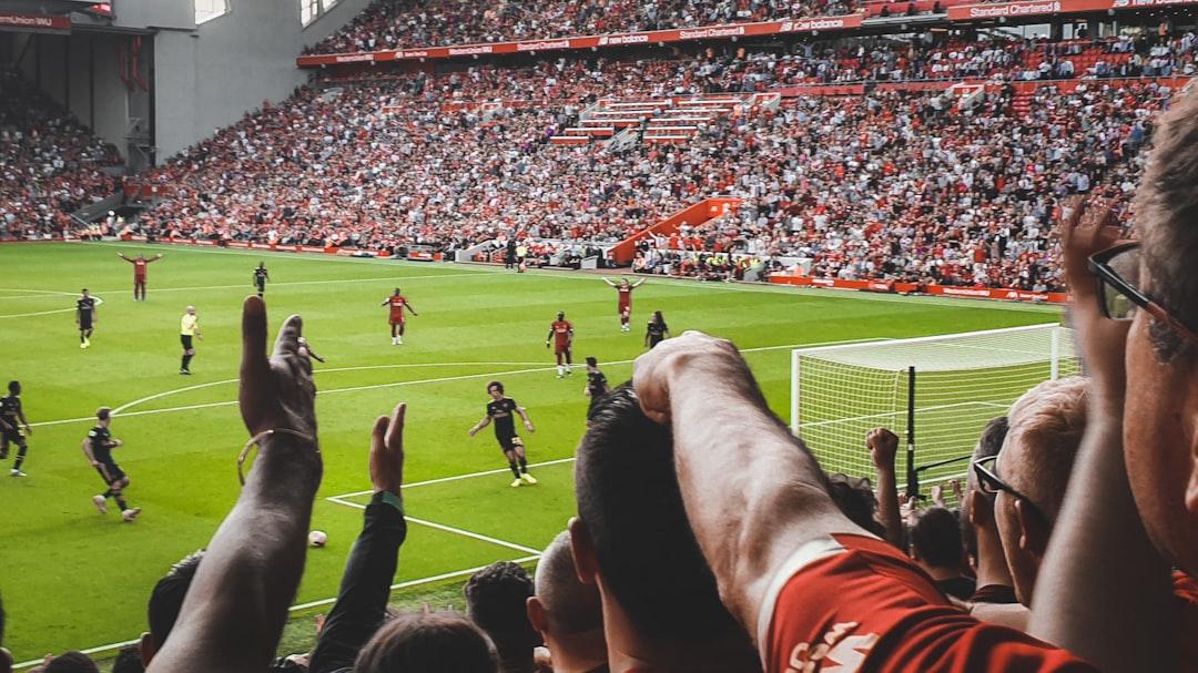 A crowd of people watching a soccer game at Anfield