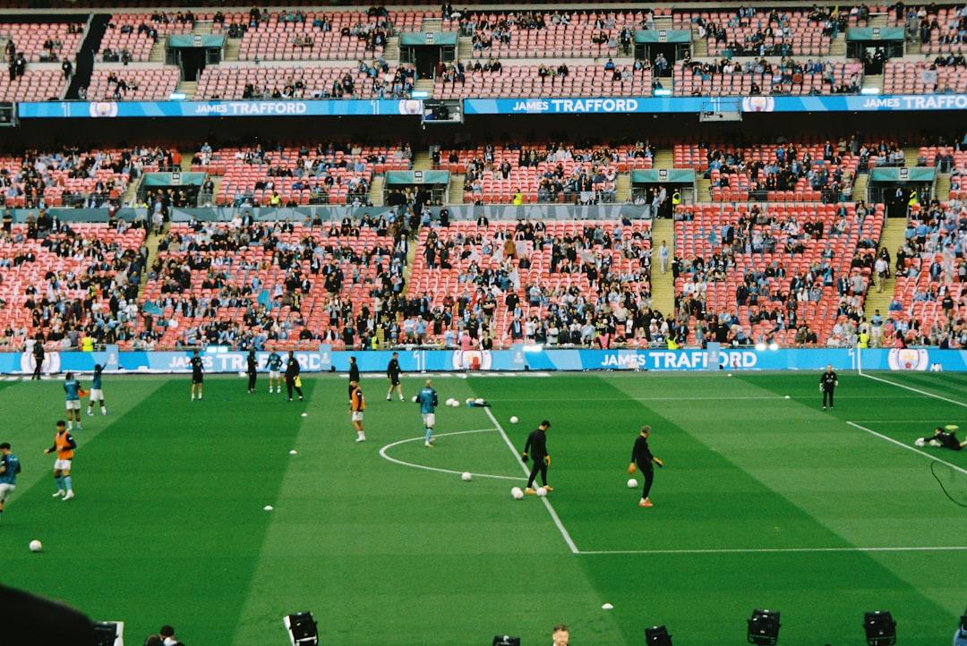 Soccer players warming up on a field in a stadium