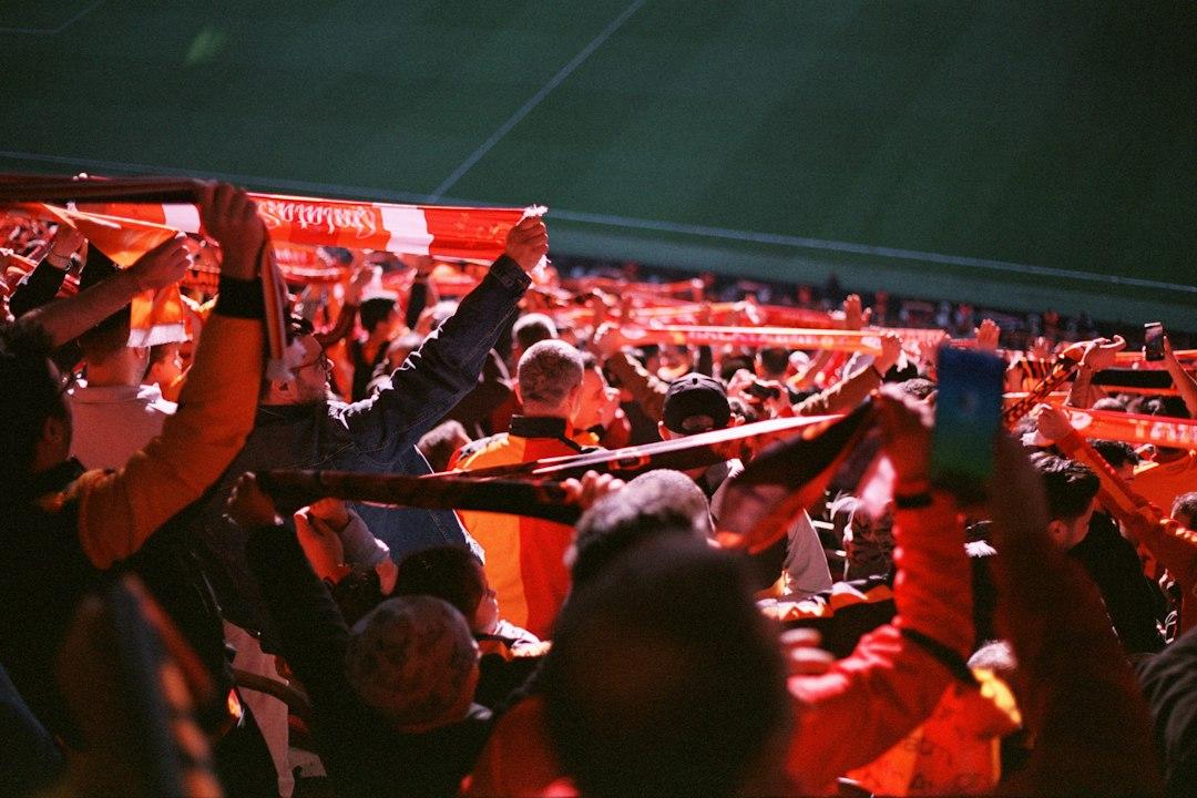 A packed stadium of fans watching a dramatic match
