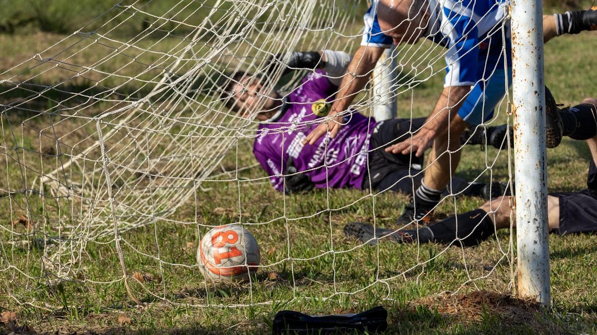 A goalkeeper and outfield players in action during a match
