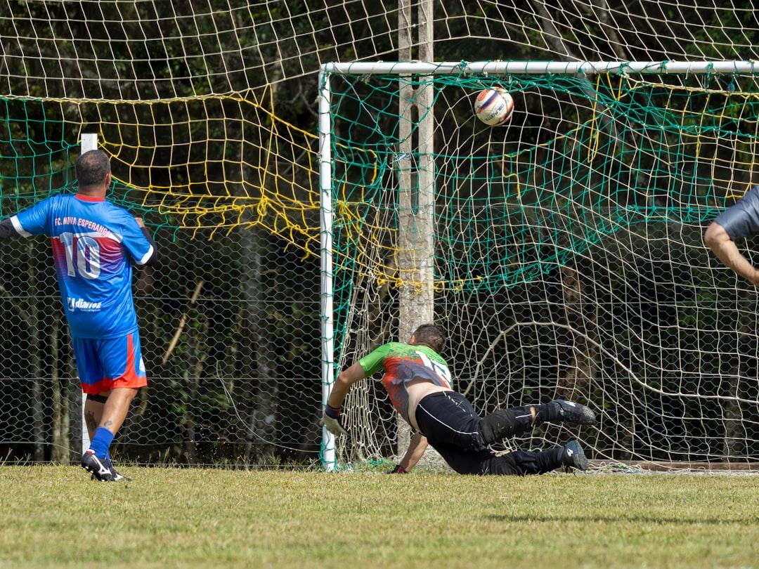 Goalkeeper dives to save a soccer goal during a match