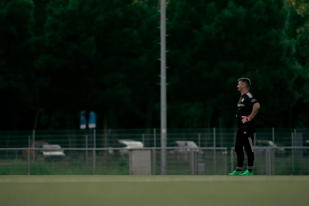 A goalkeeper standing on a football pitch