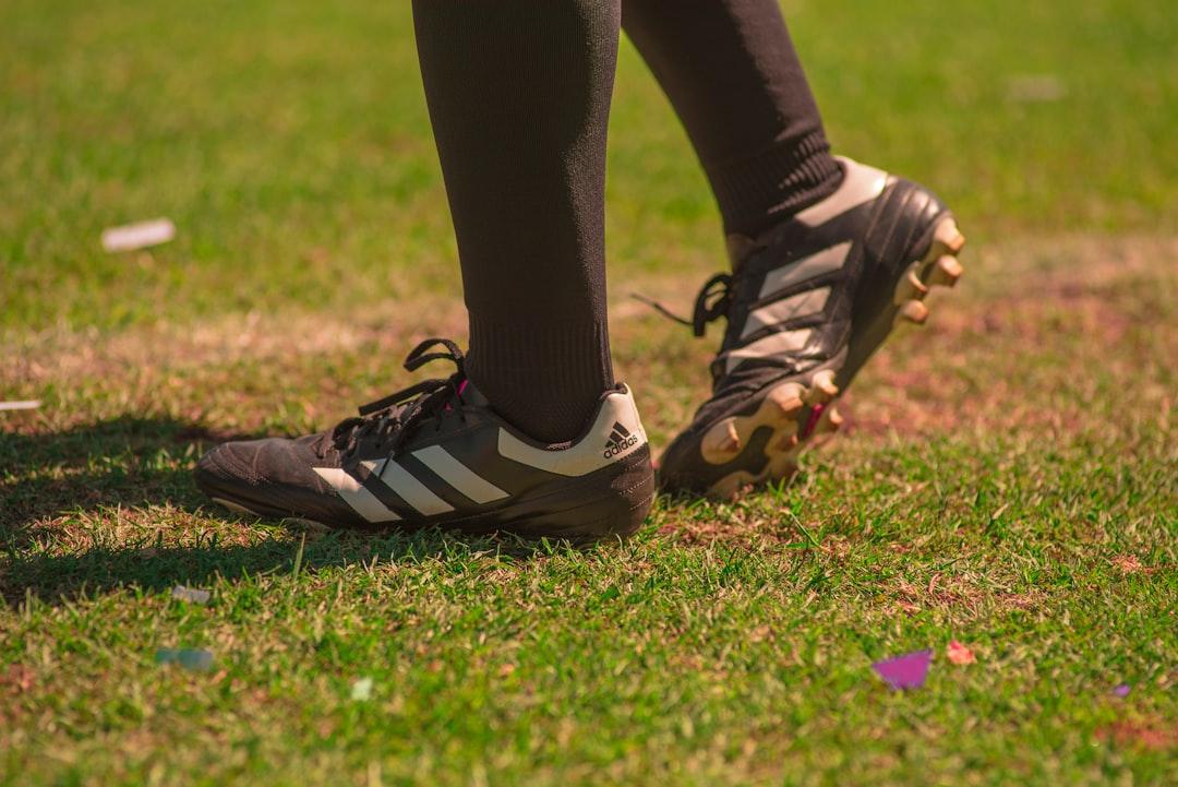 A soccer referee standing on the pitch during a match