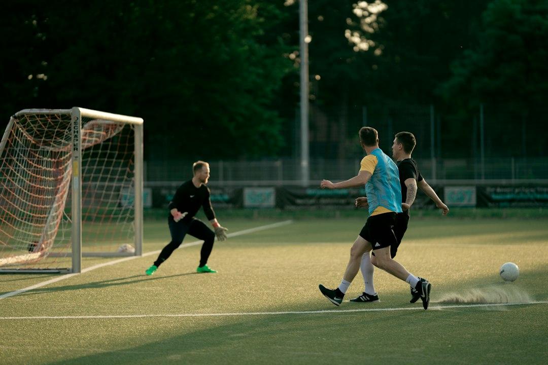 A group of players moving off the ball during a soccer match
