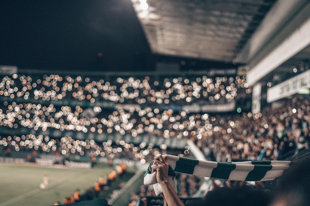Person holding a green and white striped football shirt