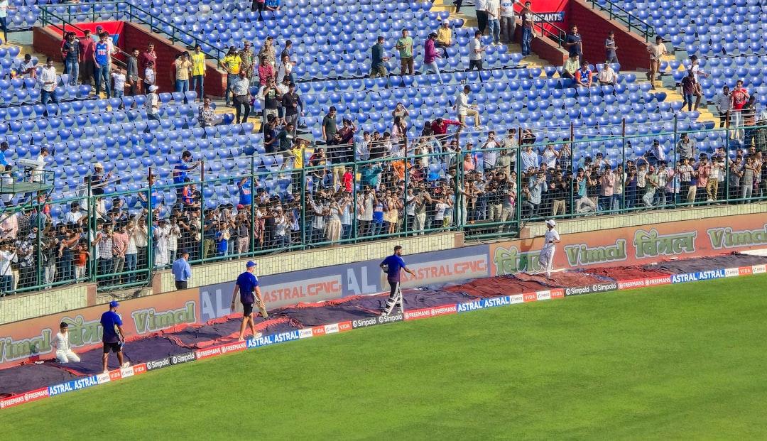 Spectators watch a game from stadium seats.