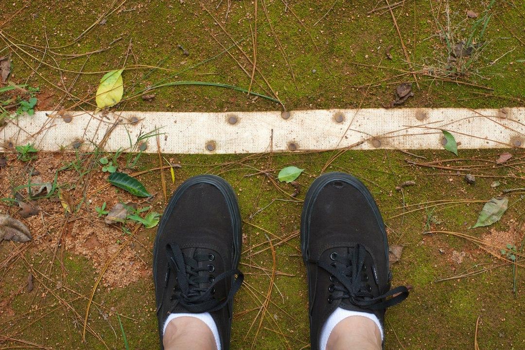Football boots on a grass pitch before kickoff