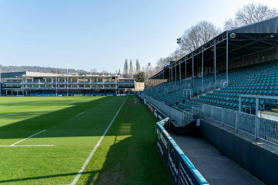 Empty stadium seating overlooking a green pitch