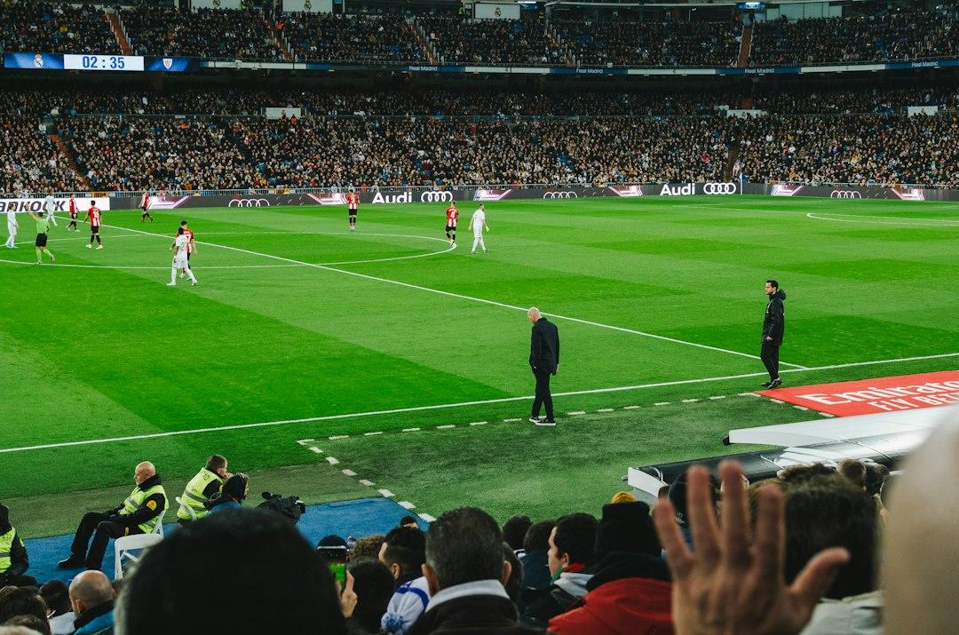 Fans watching a soccer match inside a packed stadium