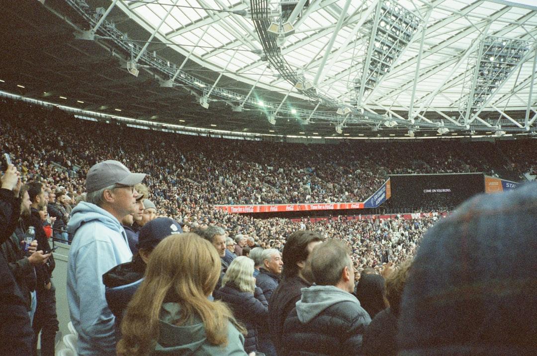 A large crowd fills a modern stadium during an event