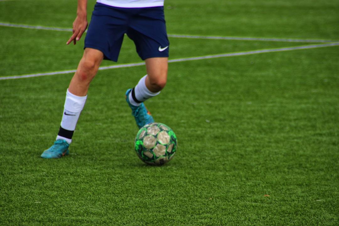 A football player striking the ball during a free kick