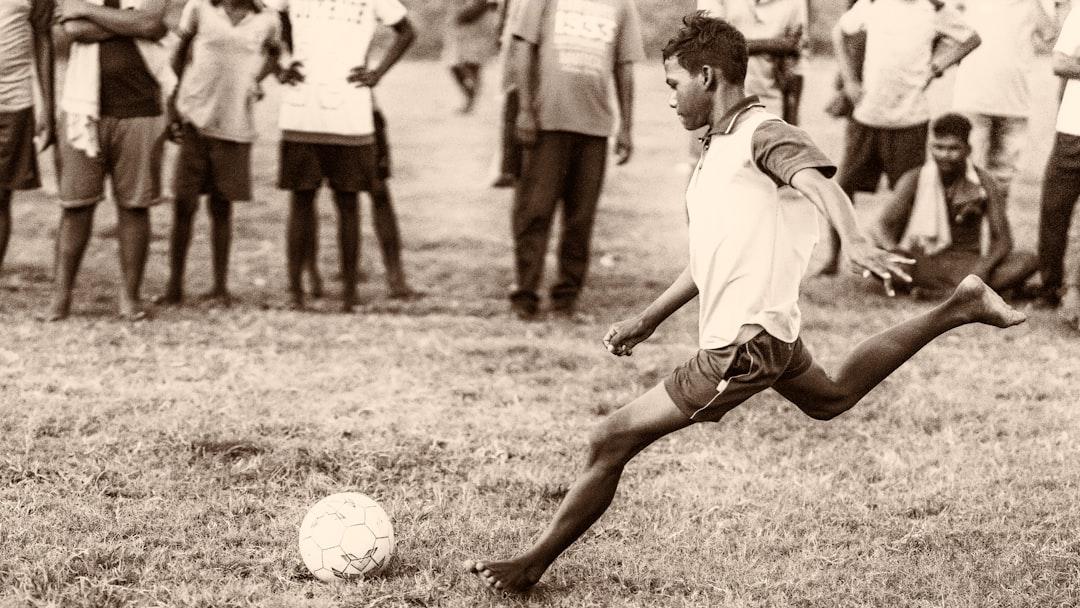 Two players contesting a free kick on a football pitch