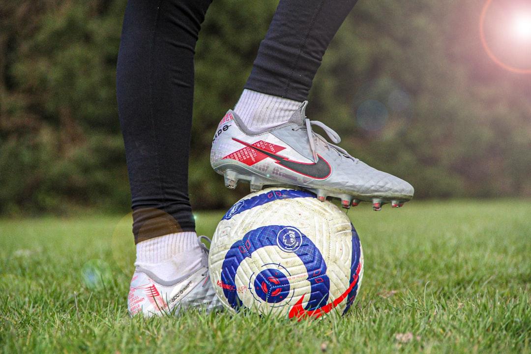 A football player in cleats on the pitch