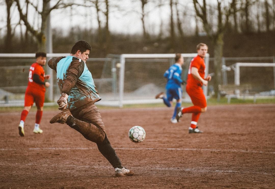 Footballers lining up at a free kick during a match