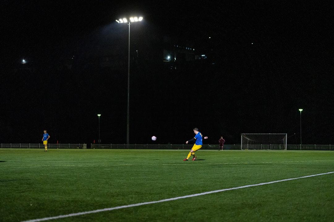 A player lining up a free kick at night
