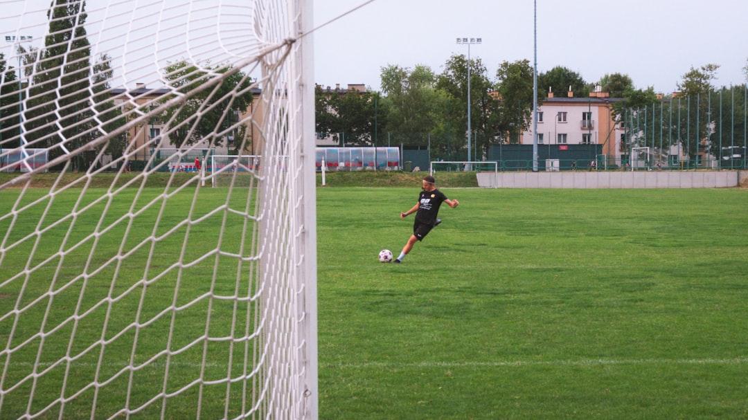 A defender prepares to clear a free kick near his own goal