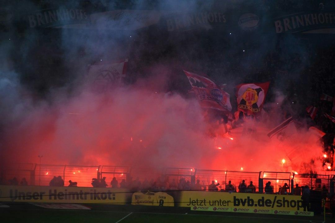 A large crowd of fans watching a soccer match