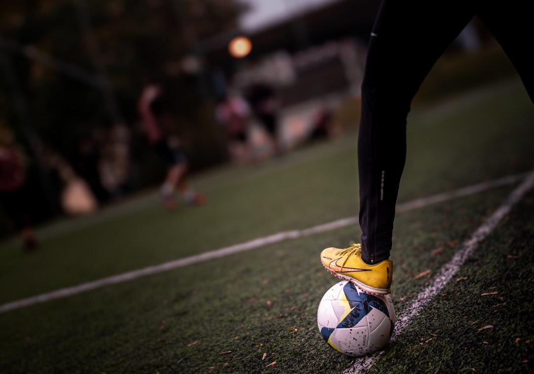 A soccer player controlling the ball before a free kick