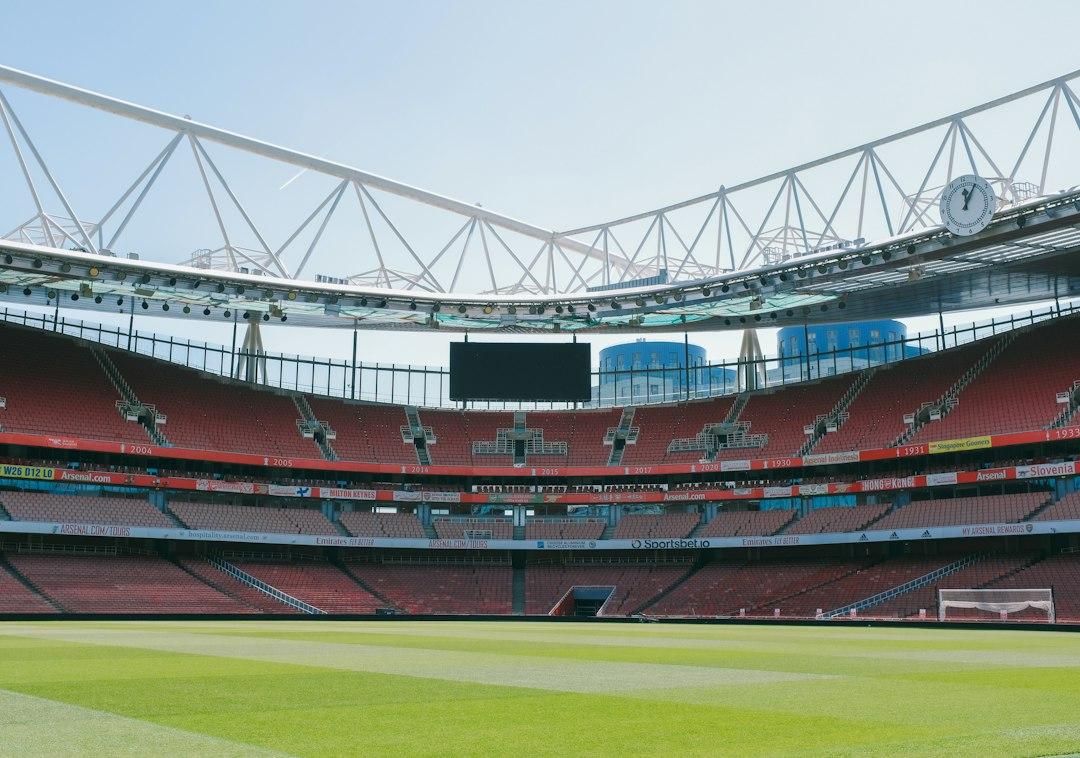 A large empty stadium with a green field