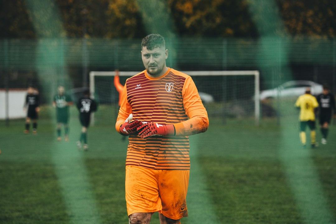 A referee stands on the pitch before a match