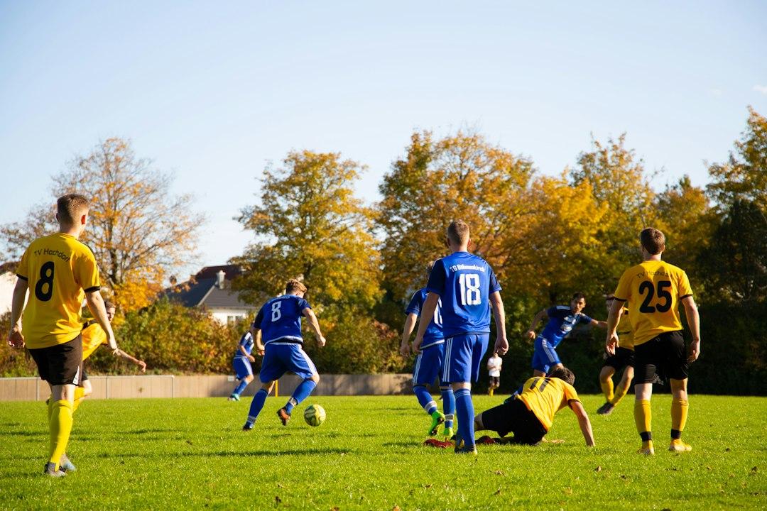 Men playing soccer under stadium lights