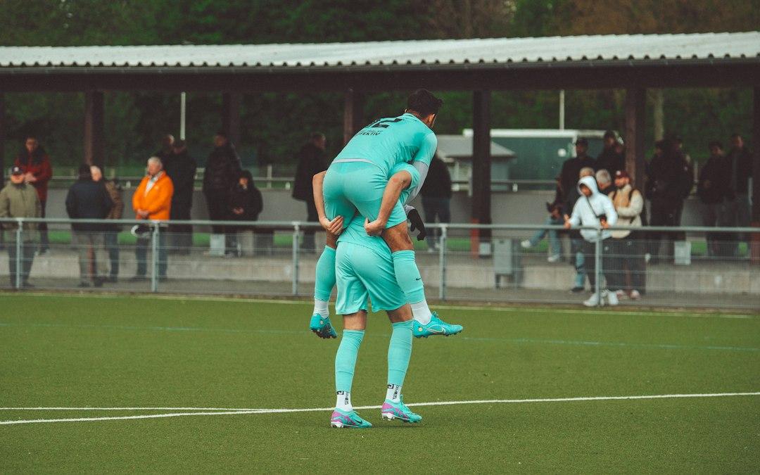 Officials and players on a soccer pitch before a match