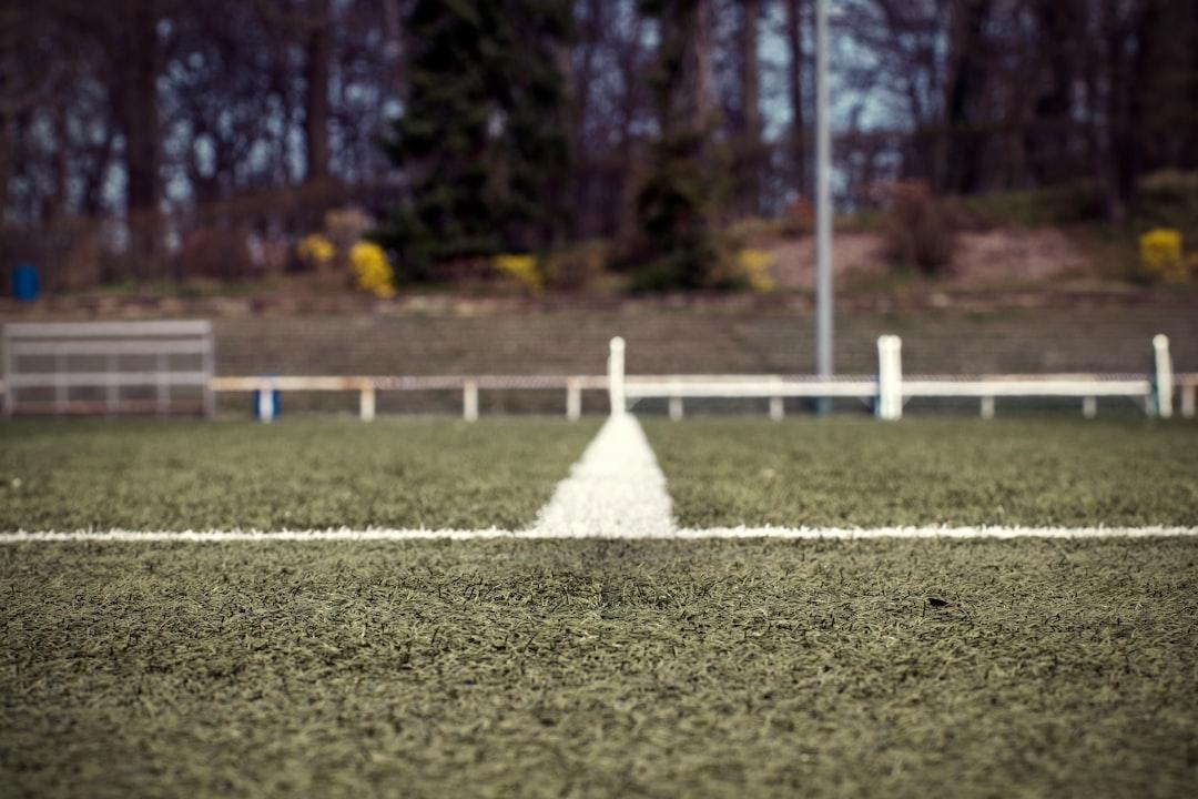 A green grass soccer field during daytime