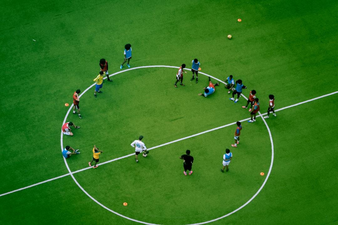 Youth soccer players practicing drills on a green field