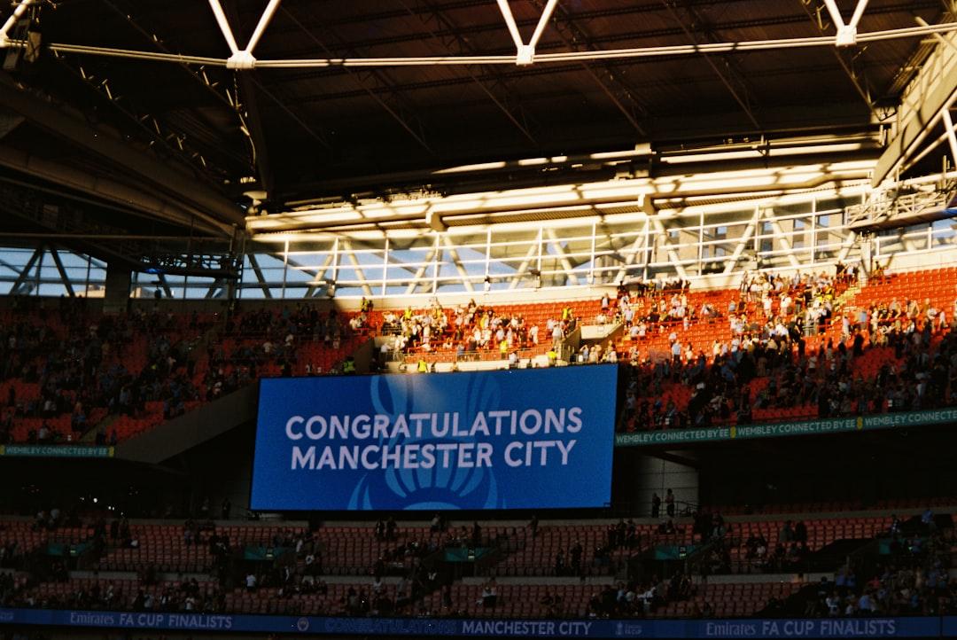 Fans watching a stadium screen during a match