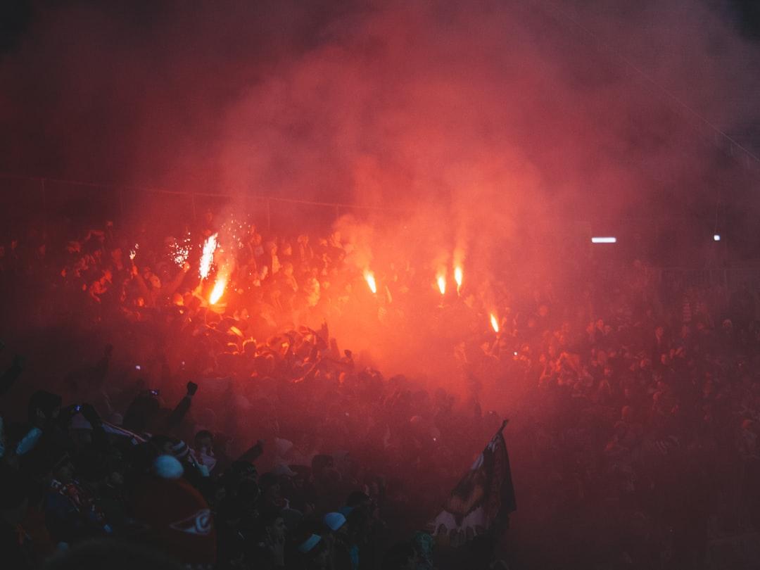 Football fans in a crowd rooting for their team