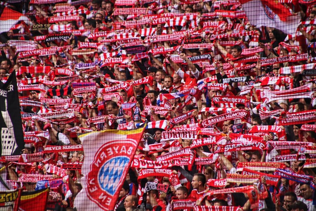 Football fans holding club flags at the Allianz Arena