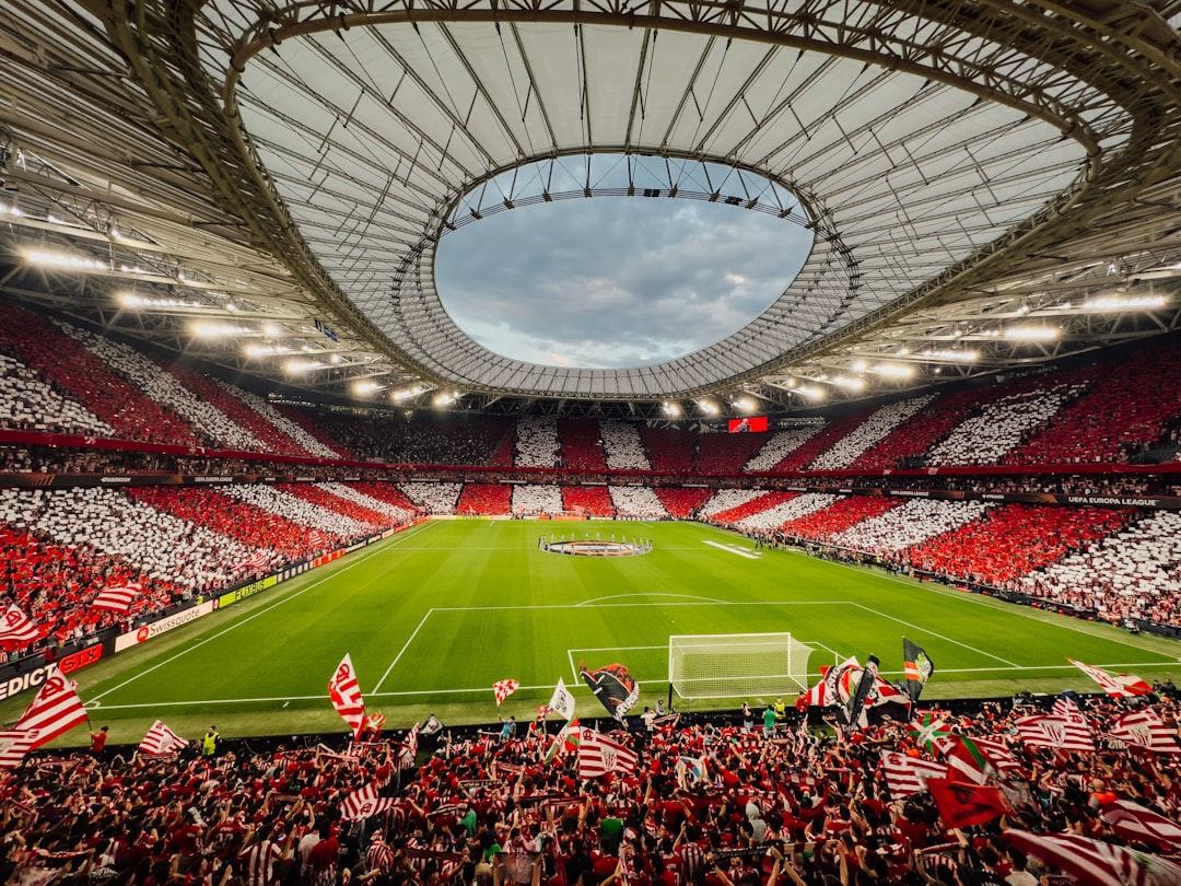 A packed football stadium with supporters cheering