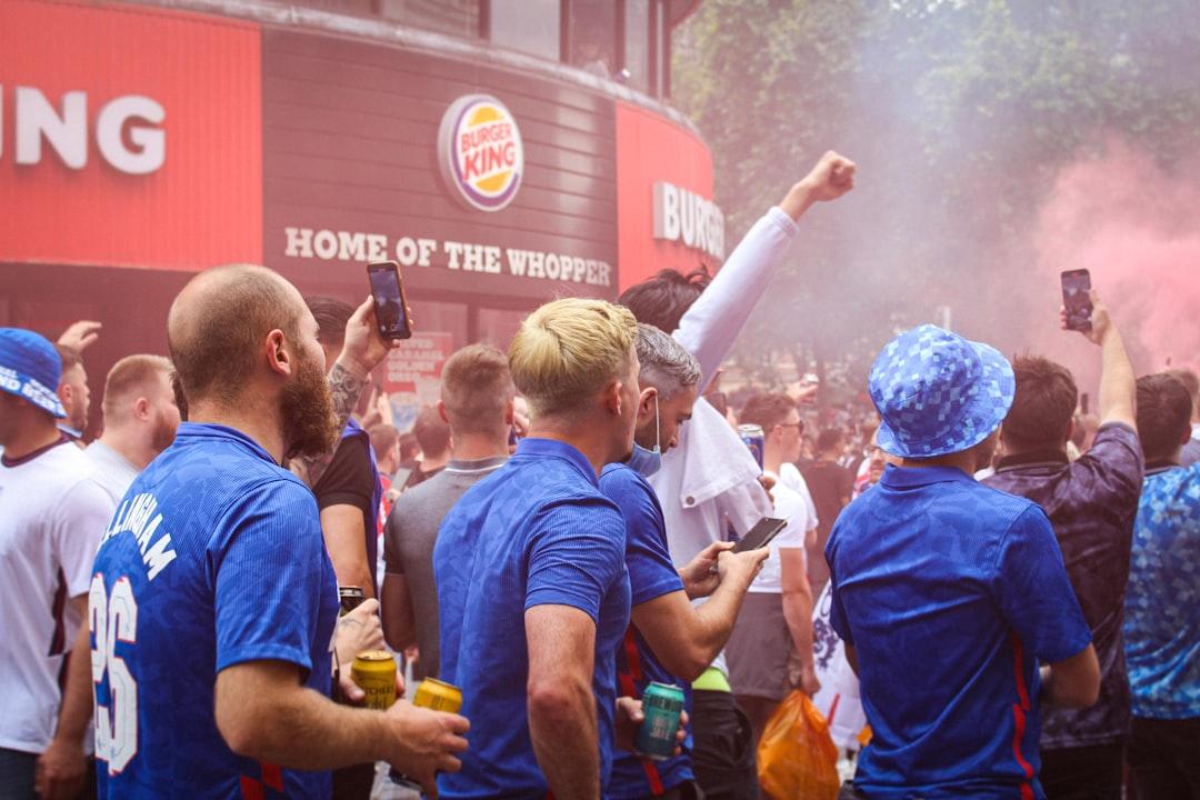 Football fans reacting and celebrating together during a live match