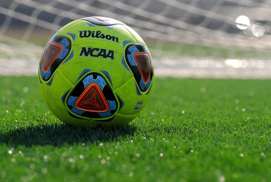 A football on the grass, ready for a matchday prediction