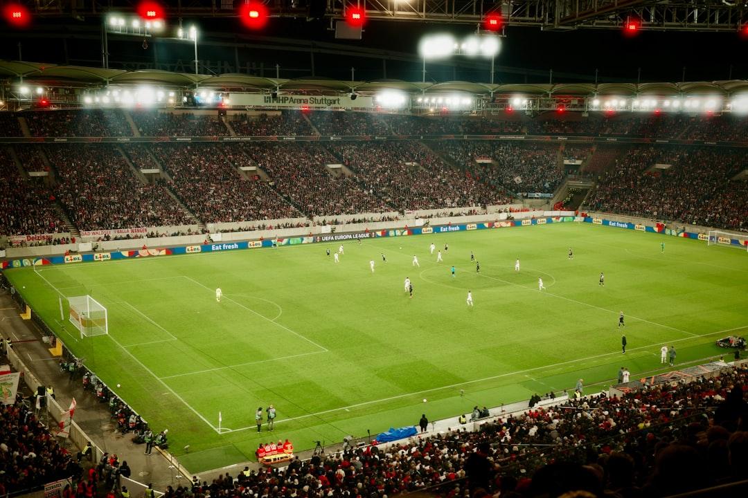 Soccer game played in a packed stadium at night