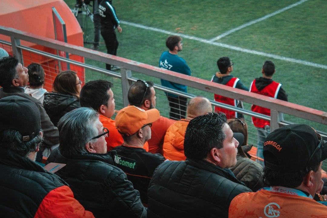 A football match in progress with officials and players on the pitch