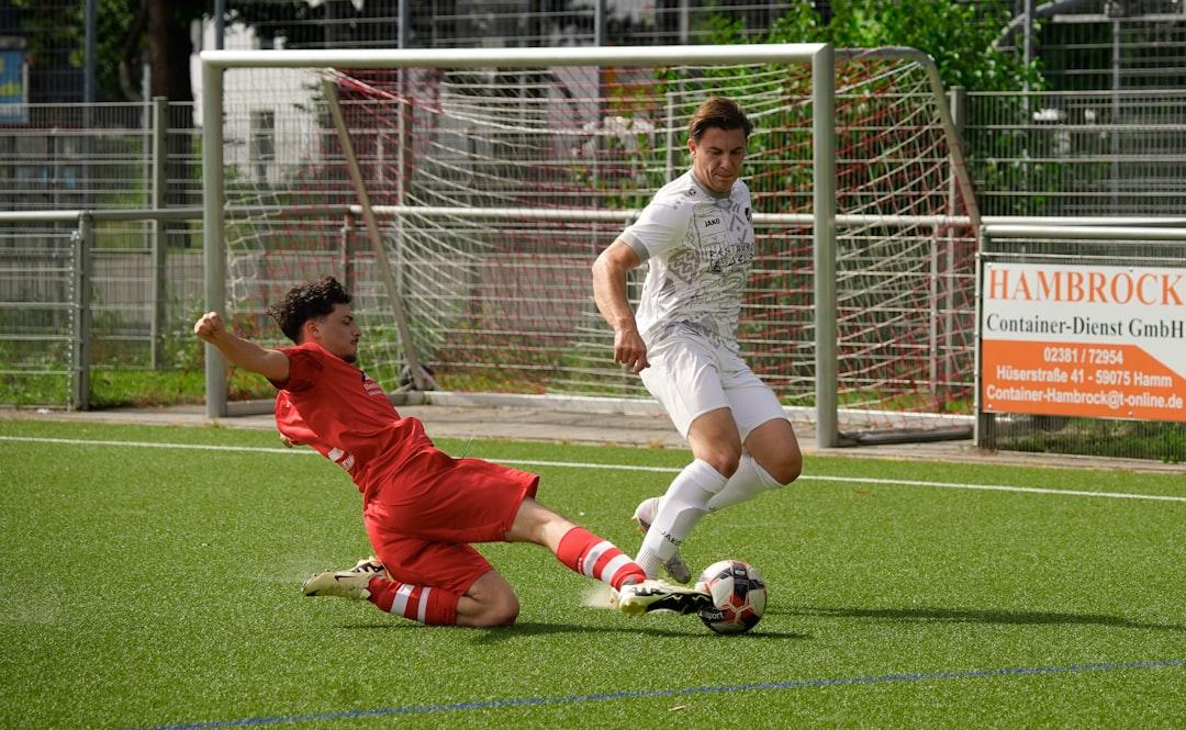 Two footballers challenging for the ball during a match