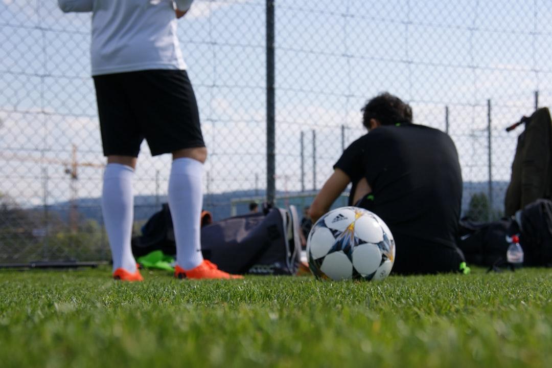 A soccer player in mid-action on the pitch during a match