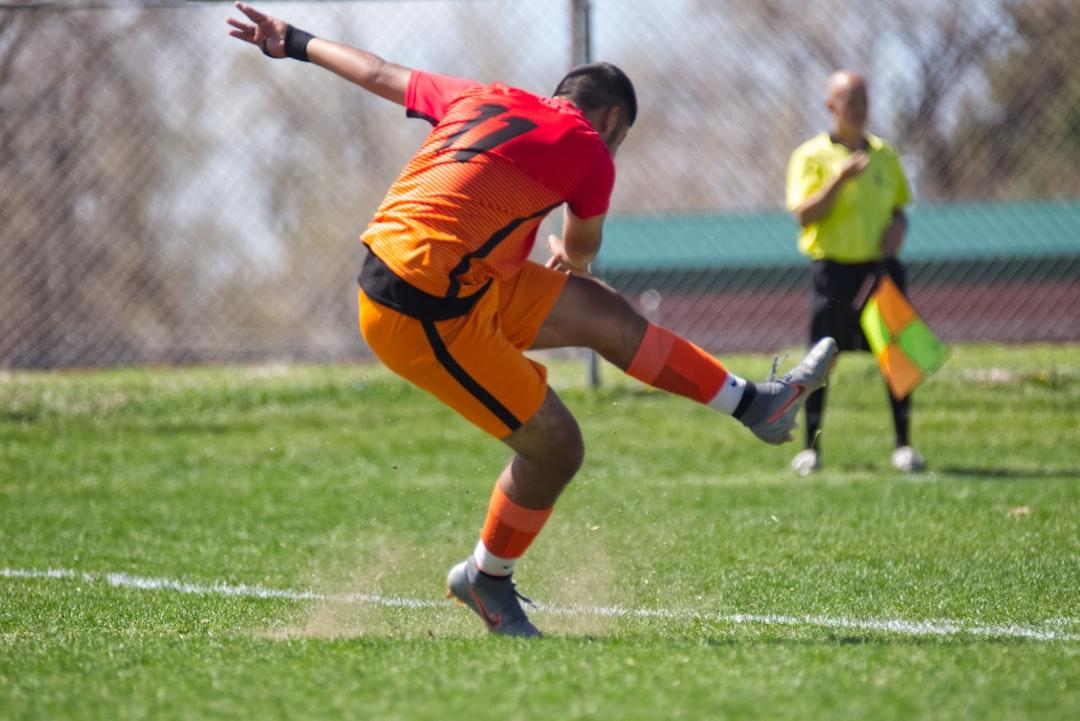 A soccer player in action on a green pitch during a match
