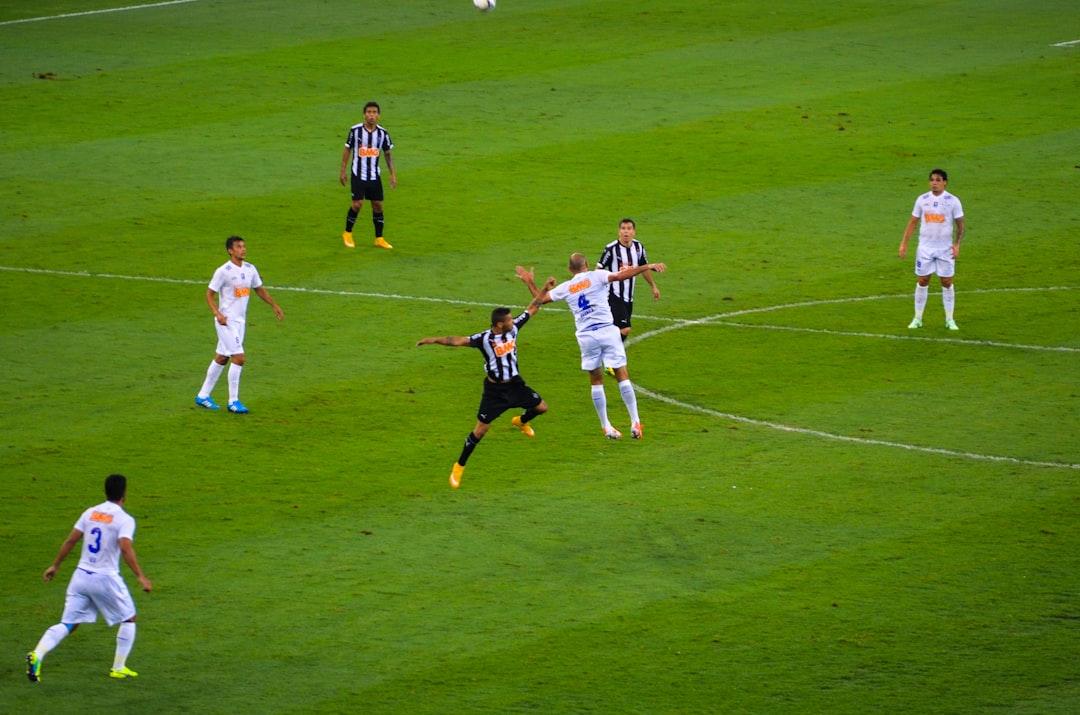 Soccer players competing on a green pitch during a match