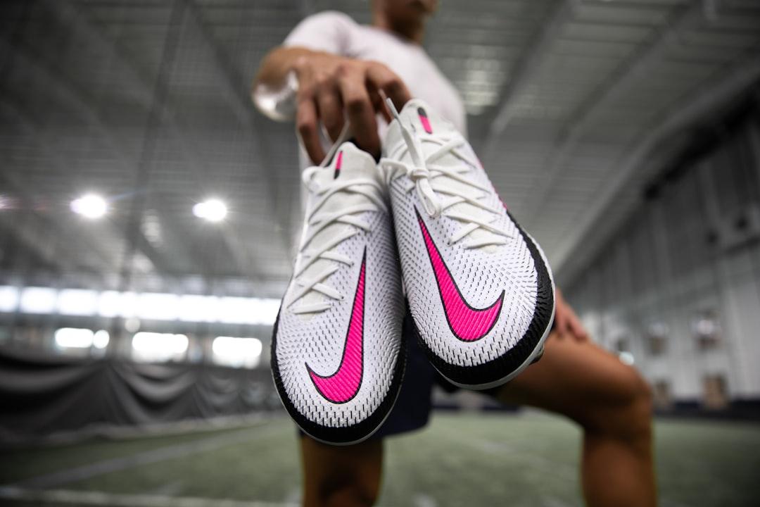 A pair of Nike football boots resting on grass