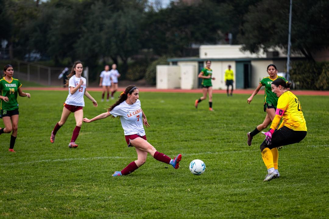 Soccer players competing on a green pitch