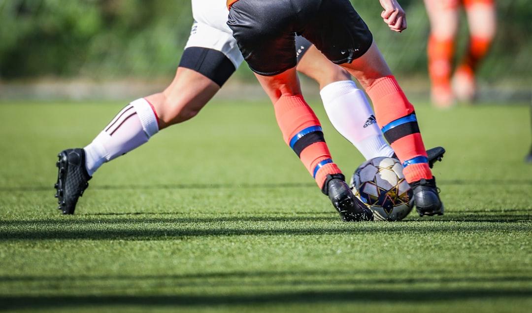 A soccer player in action on a green field during the day