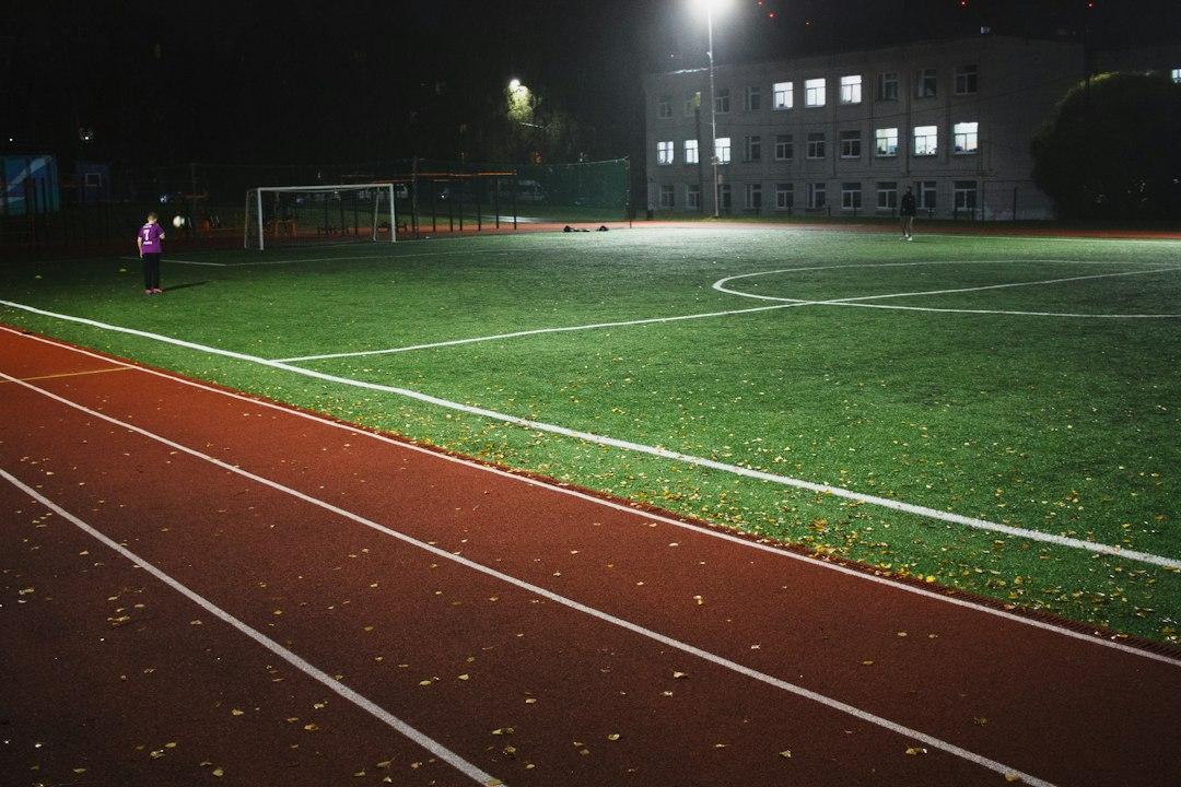 A soccer field at night under floodlights
