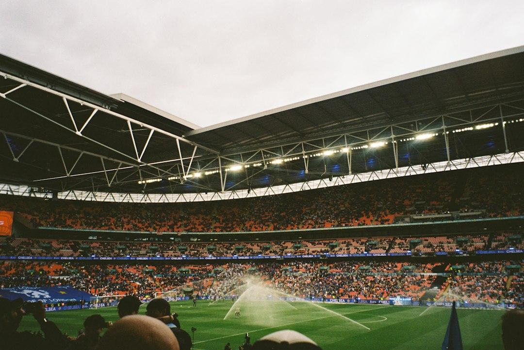 A stadium pitch under sprinklers before kickoff