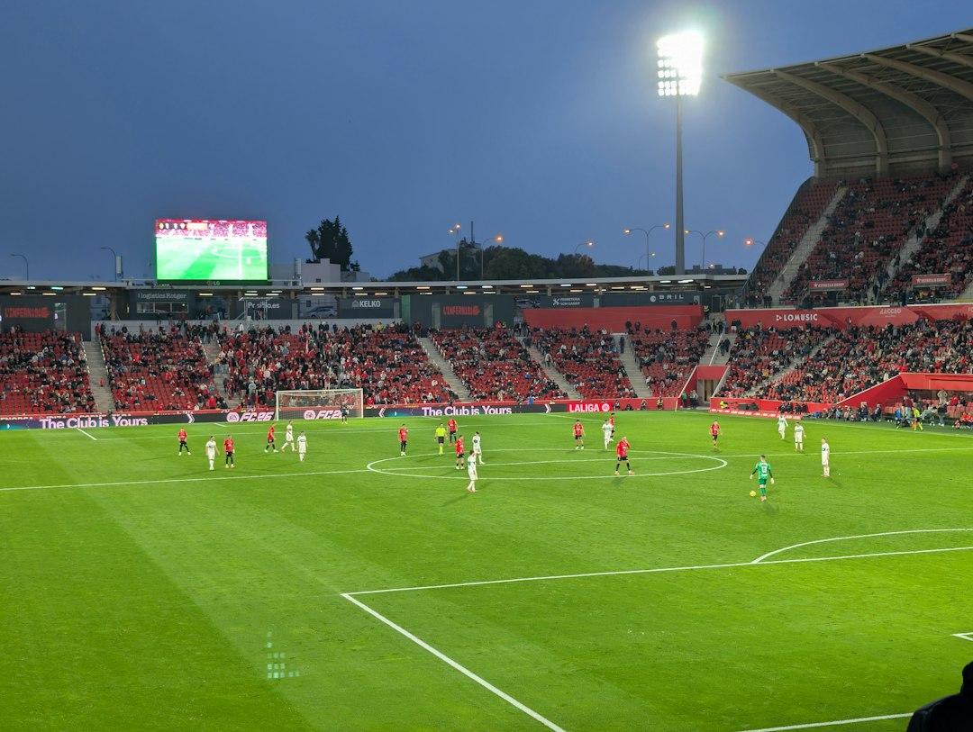 Soccer game in progress at a stadium at dusk