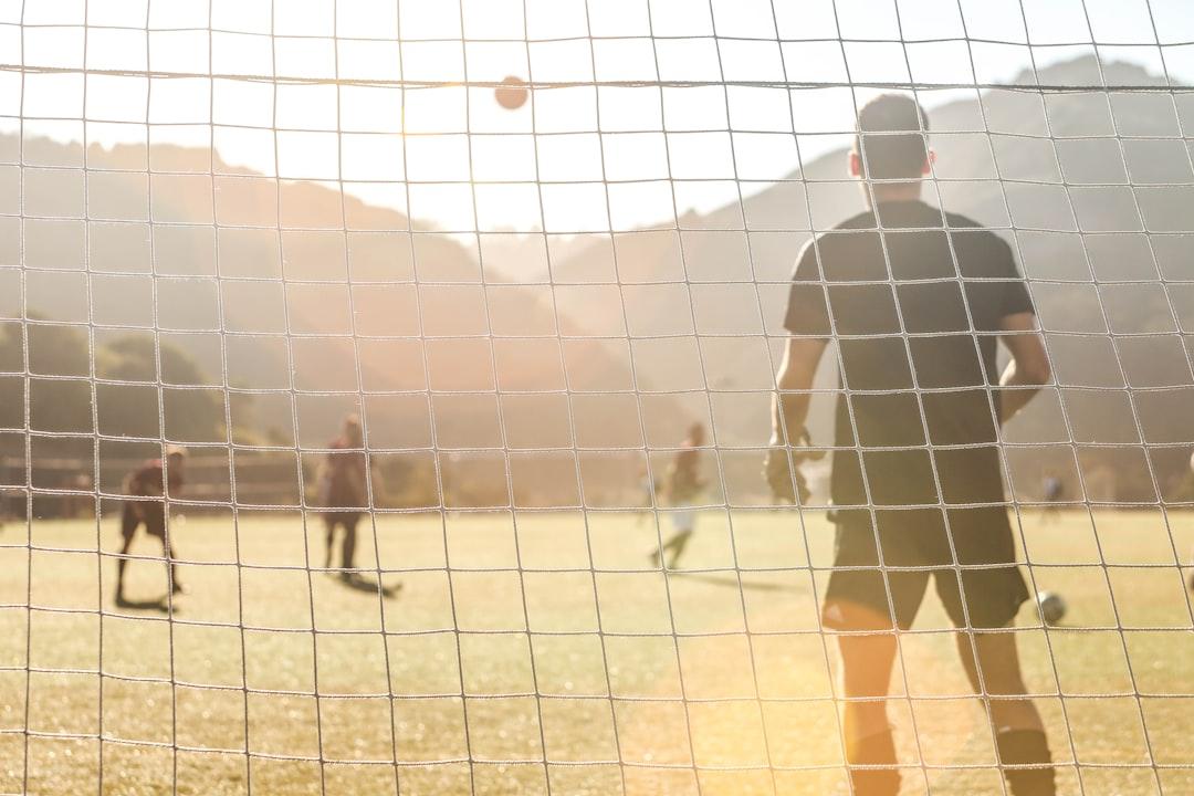 Men playing soccer on a field