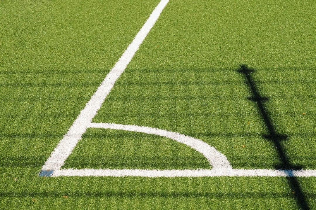 A floodlit stadium pitch awaiting kickoff