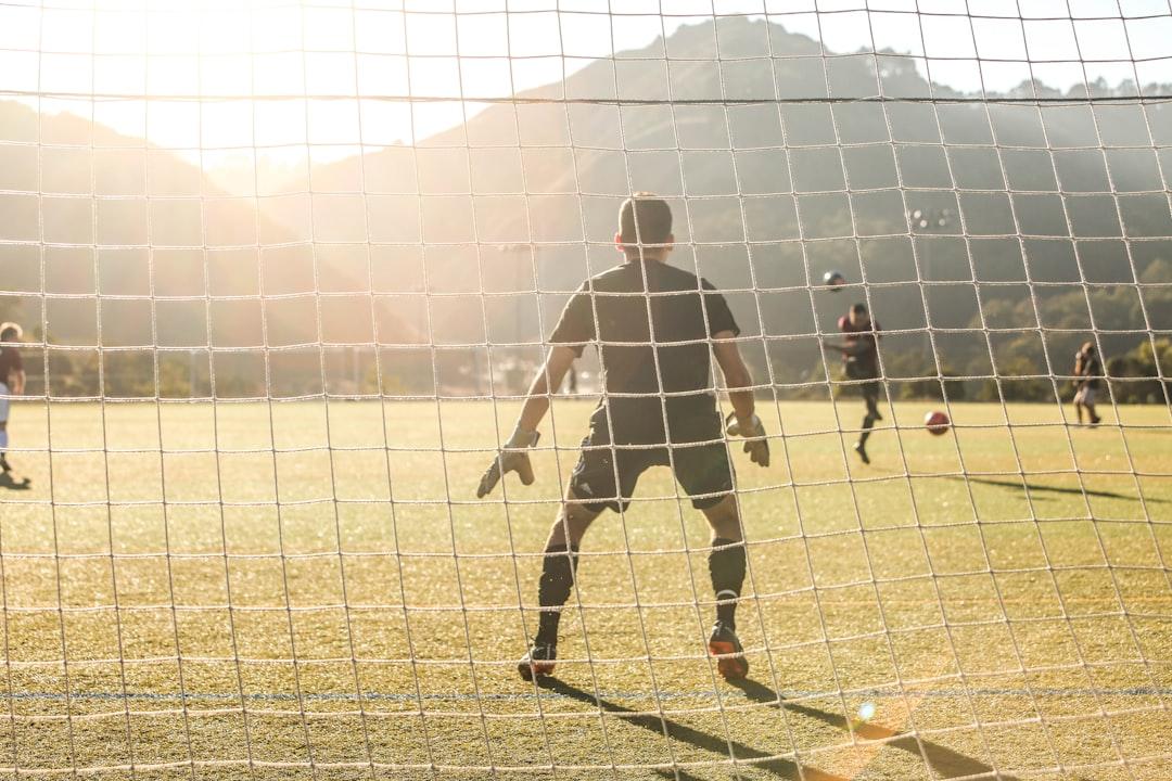 Two soccer players competing for the ball on the pitch